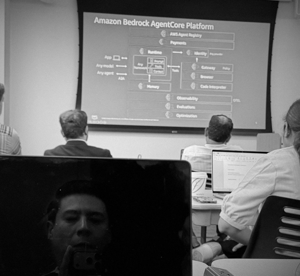 Luis Canedo reflected in his laptop screen during an AI agent architecture session